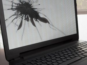 black laptop with a white broken screen