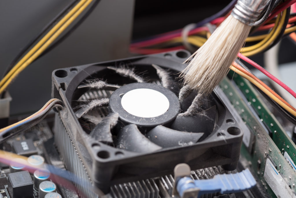 Computer fan, being cleaned to increase air-flow